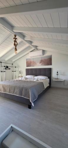 a bedroom with a large bed in a white room at Home Dimitra in Grammatikiánoi