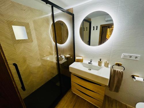 a bathroom with a sink and a mirror at Casa Cazorla in Ojén