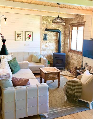 a living room with a couch and a blue stove at Holiday house Flores near Kolasin in Kolašin