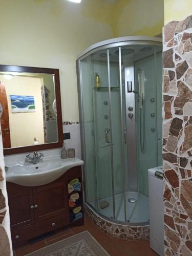 a bathroom with a shower and a sink and a mirror at Casa Maria in Matzaccara