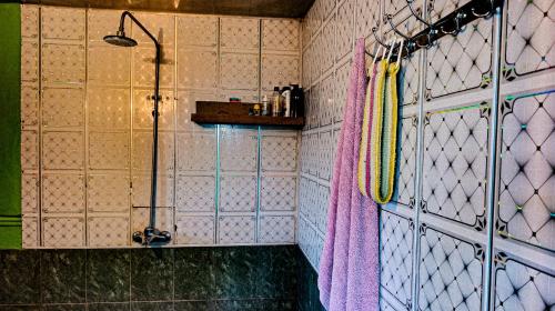 a bathroom with a shower and a shower curtain at Sarvan's Khinalig Riverside Montain House in Xınalıq