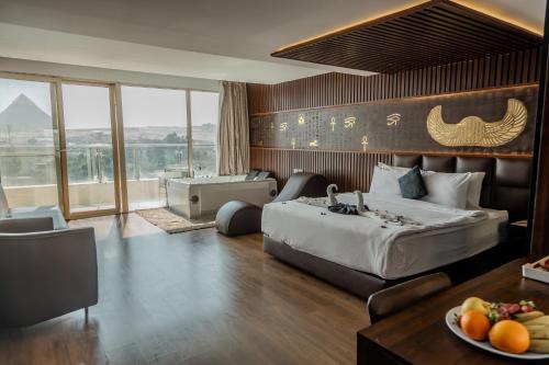 a hotel room with a bed and a table with a plate of fruit at Hotel Comfort Giza in Cairo