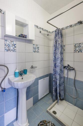 a bathroom with a sink and a shower at Stamatis Rooms in Skopelos Town