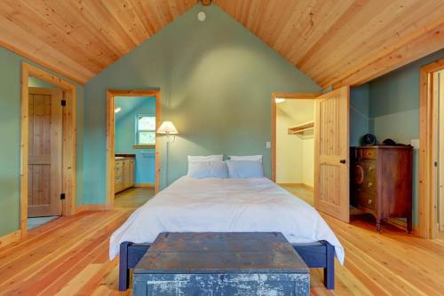 a bedroom with a large bed and a wooden ceiling at The Osprey Perch in Garfield