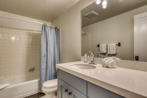 a bathroom with a sink and a toilet and a mirror at Single Level Ranch Condo in Elkhorn in Sun Valley