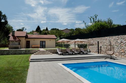 a backyard with a swimming pool and a house at Lastva Nature Retreat in Mostar