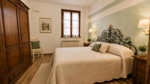 a bedroom with a bed and a cabinet and a window at Villa Mandrioli in Cecina