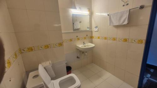 a bathroom with a toilet and a sink at Secret kitchen rooms in Candolim