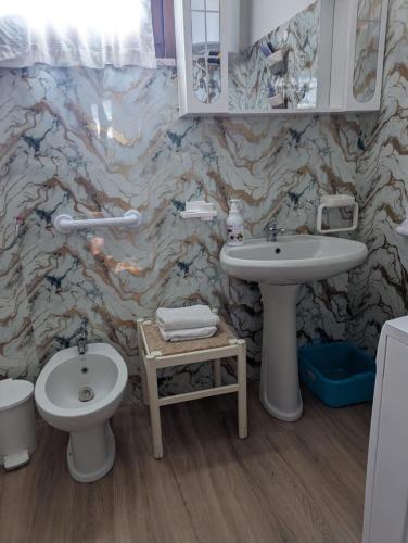 a bathroom with a sink and a toilet at Villa cesar in Costa Paradiso
