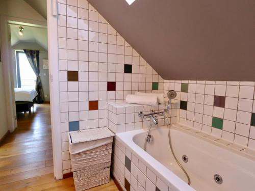 a bathroom with a bath tub in a room at Cocoon in Houffalize