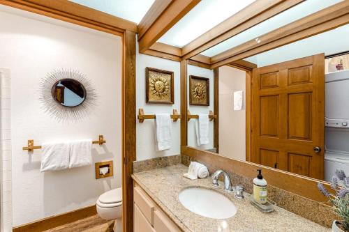 a bathroom with a sink and a toilet and a mirror at Snowcreek 1580 in Sun Valley