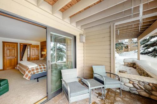 a room with a balcony with two chairs and a bedroom at Snowcreek 1580 in Sun Valley