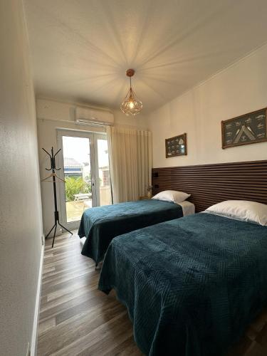 a hotel room with two beds and a window at Villa Populo in Ponta Delgada