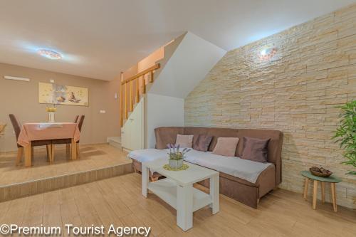 a living room with a couch and a table at Milena Sea & Mountain View in Zubovići