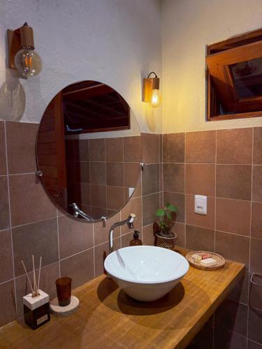 a bathroom with a sink and a mirror on a counter at Casa do Rio Âmbar - Alter do Chão in Santarém