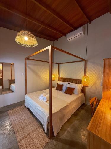 a bedroom with a canopy bed in a room at Casa do Rio Âmbar - Alter do Chão in Santarém