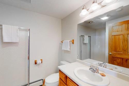a white bathroom with a sink and a toilet at Jay Peak Village Home 367A in Jay