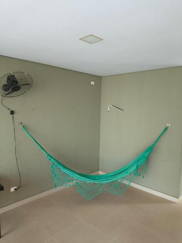 a room with a hammock hanging on a wall at Espaço MGS in Foz do Iguaçu