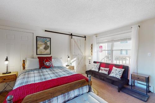 a bedroom with a bed and a couch in it at Sweet Retreat & Dream Weaver in Ludlow