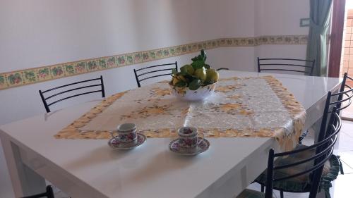 a white table with a bowl of fruit on it at Casa Dolce Armonia in Augusta