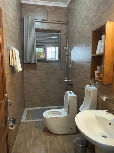 a bathroom with a toilet and a sink at KIGALI FANTASTIC Aparthotel in Kigali