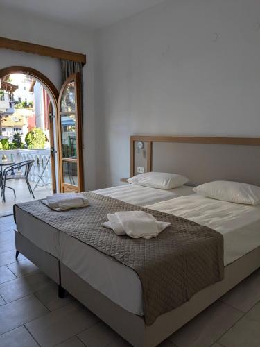 a bedroom with a bed with two pillows on it at Two Brothers Parga in Parga