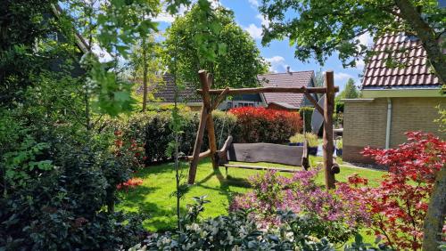 a swing in the middle of a garden at Ferienhaus Weitblick in Sint Maarten