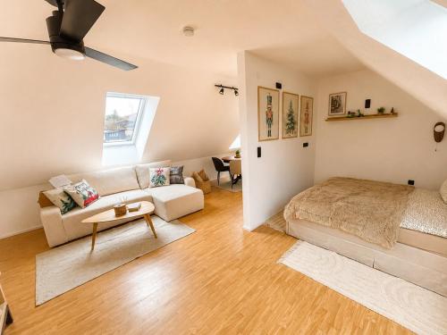 a bedroom with a bed and a living room at All Homes Apartments Bad Schallerbach in Bad Schallerbach