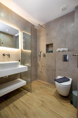 a bathroom with a toilet and a sink and a shower at Sea U - Apartment in Skala Marion