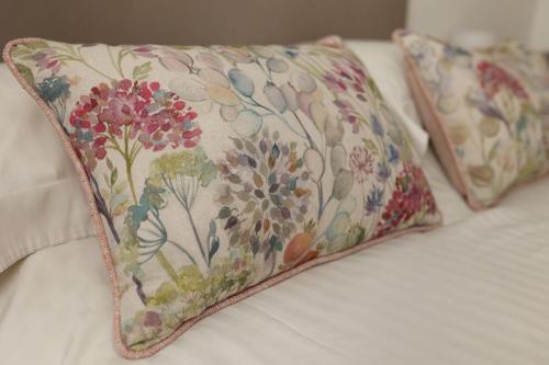 two pillows sitting on top of a bed at Westlea Cottage in Turriff