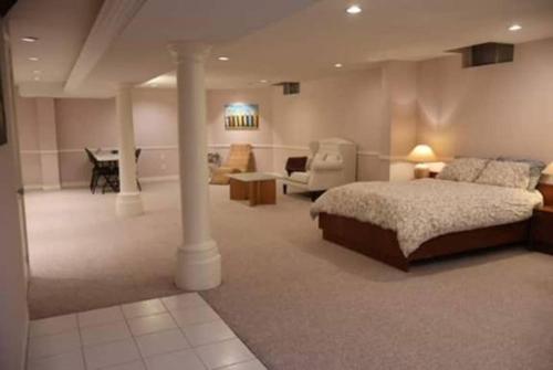 a bedroom with a bed and a living room at Cozy Family Suite, entire place with two beds, pravite washroom and kitchen in Markham