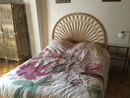 a bed with a comforter on it in a room at Maison des barrys in Ispagnac