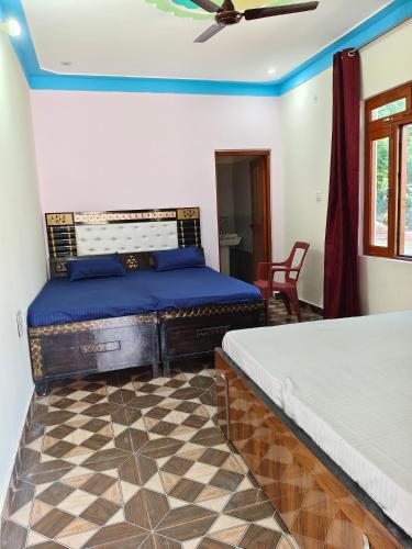a bedroom with two beds and a ceiling fan at Himalayan due lodge chopta in Sari