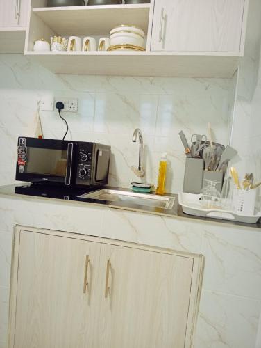 a microwave sitting on top of a kitchen counter at Bliss Apartments in Nakuru