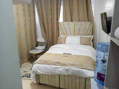 a bedroom with a bed with a canopy at Bliss Apartments in Nakuru