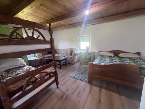a bedroom with two bunk beds and a couch at Konak Vrela Žabljak in Žabljak