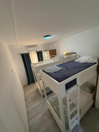 a bedroom with a bunk bed in a room at Marina in Shëngjin