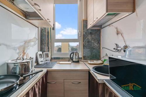 a kitchen with a sink and a window at MILANO Bicocca Niguarda a 15min dal DUOMO in Milan