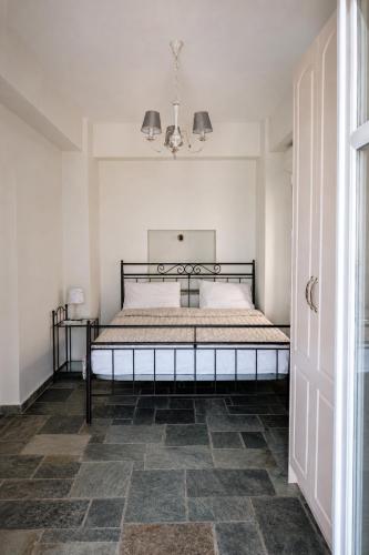 a bedroom with a bed in a white room at Stellinas House 2 in Andros