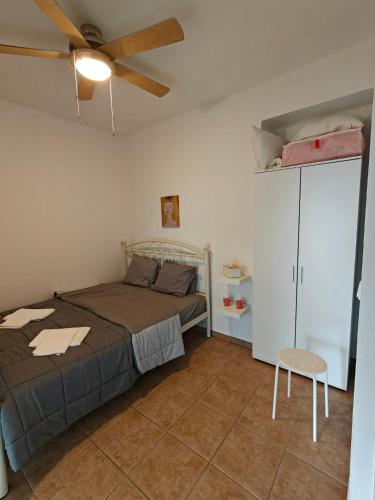 a bedroom with a bed and a ceiling fan at Eveline house in Larisa