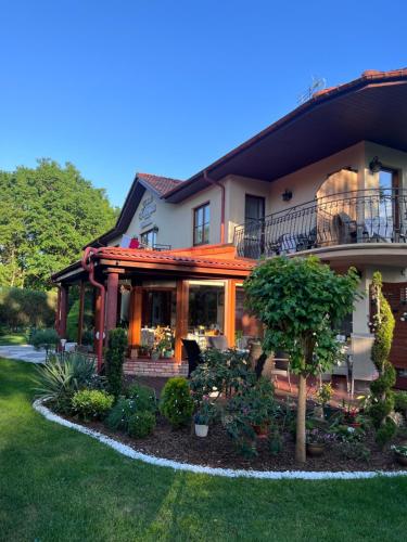 a house with a garden in front of it at Willa u Wójta in Pobierowo