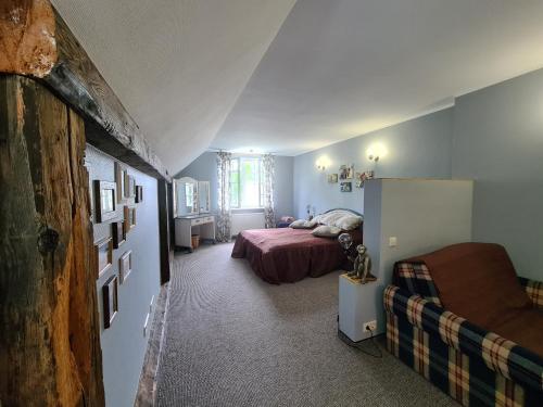 a small room with a bed and a refrigerator at Nicava in Nīca