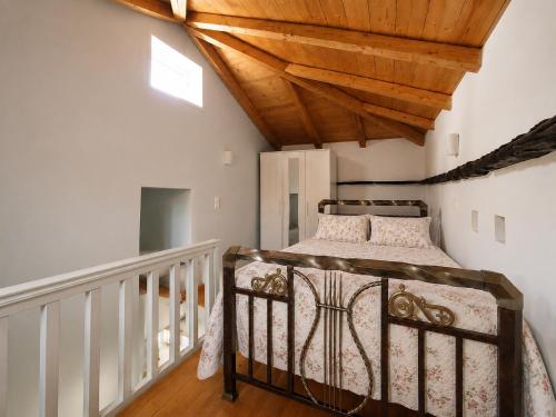 a bedroom with a bed and a wooden ceiling at Stellinas Pretty House in Andros