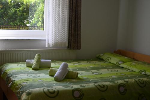 two twin beds in a room with a window at Apartma Kukč II in Bovec