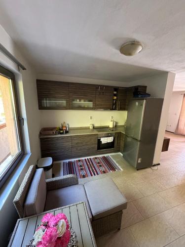 a kitchen with a couch and a table and a refrigerator at Casa Del Lago in Jablanica