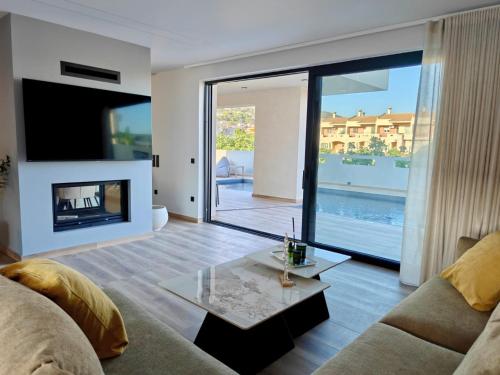 a living room with a couch and a fireplace at Aura Mare in Porto Rafti