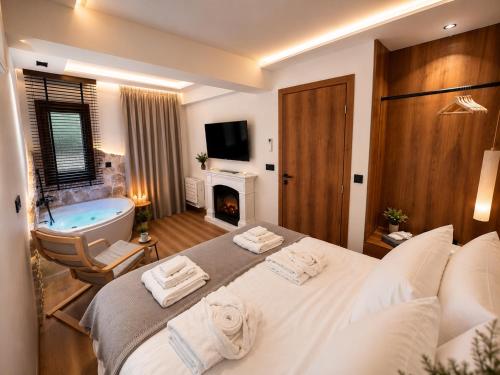 a bedroom with a large bed and a bath tub at Aje Villas 1959 in Ioannina