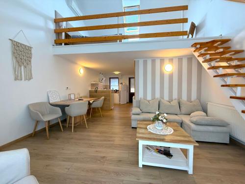 a living room with a couch and a table at Gyulai idill apartman in Gyula