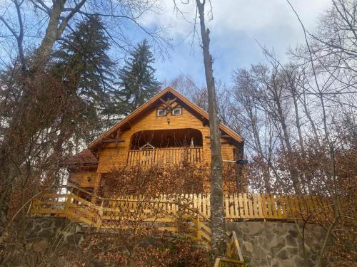 a large wooden cabin in the woods at Motobike Experience in Arkos