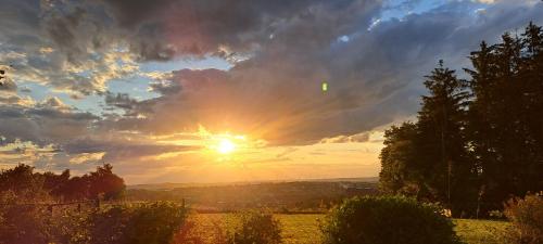 a sunset in a field with the sun in the sky at Goldener Blick in Stollberg